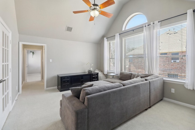 living area featuring light colored carpet, visible vents, ceiling fan, and baseboards