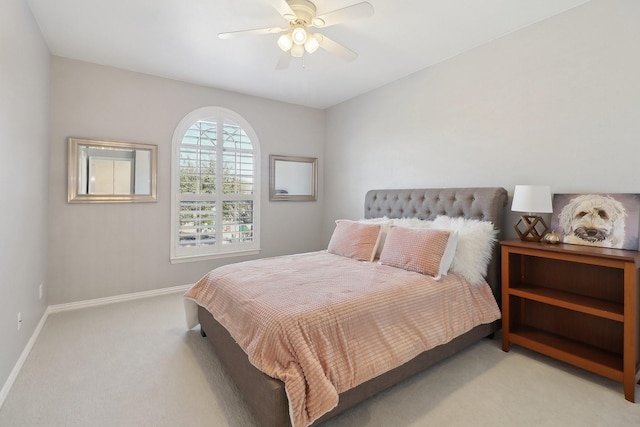 bedroom with a ceiling fan, light colored carpet, and baseboards