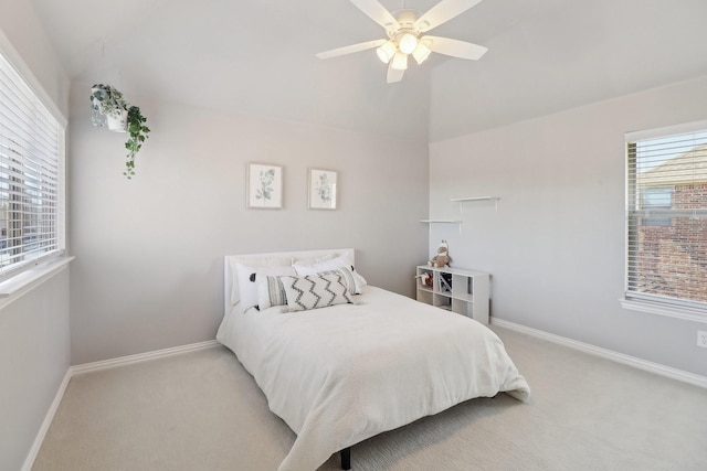 bedroom with light carpet, vaulted ceiling, and baseboards