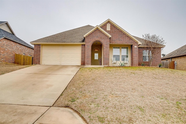 145 Redbud Ln, Weatherford, TX 76086 - single story home featuring concrete driveway, brick siding, an attached garage, and fence