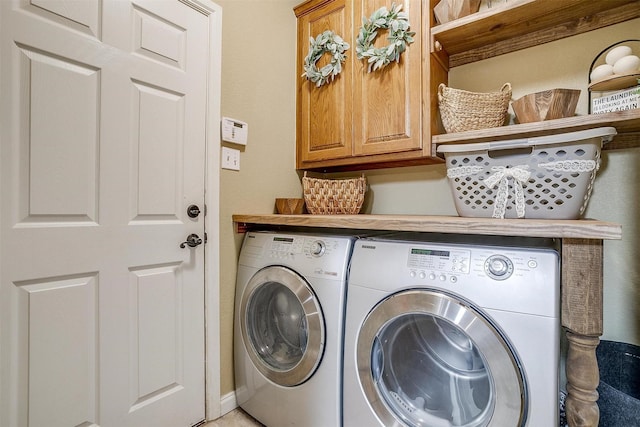 laundry area featuring cabinet space and washing machine and clothes dryer