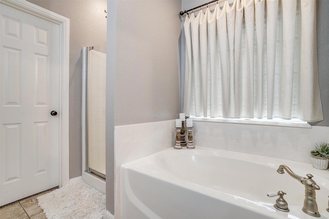 full bath featuring a shower, a garden tub, and tile patterned floors