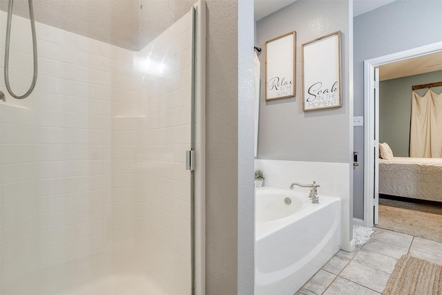 full bathroom featuring tile patterned floors, ensuite bath, a bath, and a shower stall