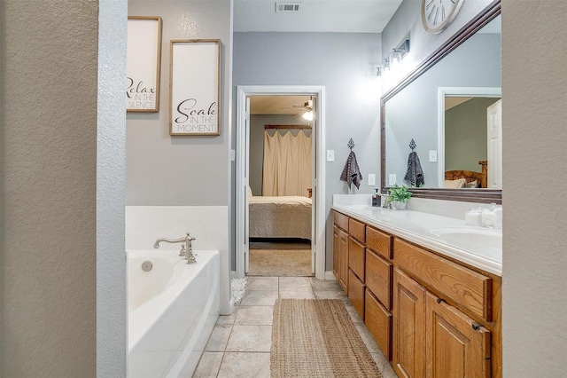 ensuite bathroom with ensuite bathroom, tile patterned flooring, a garden tub, visible vents, and double vanity