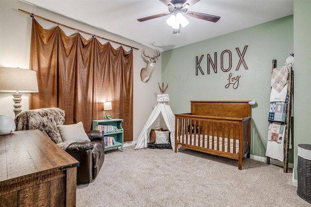 carpeted bedroom with ceiling fan and baseboards