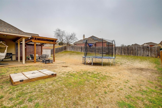 view of yard with an outdoor fire pit, a fenced backyard, a pergola, a trampoline, and a patio area