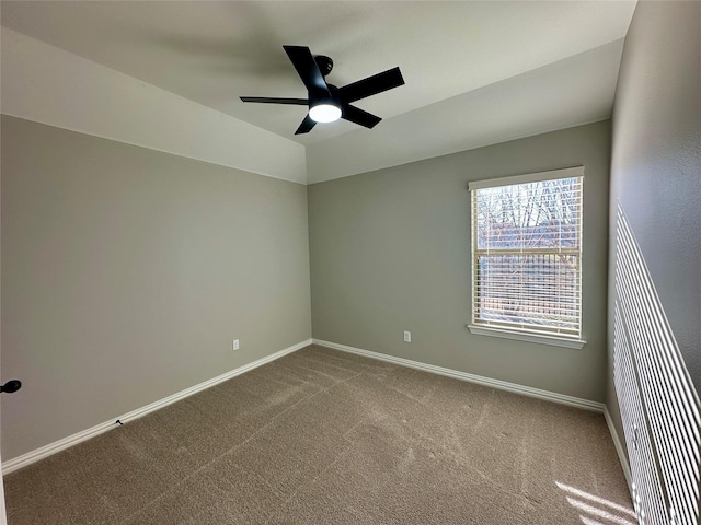 unfurnished room featuring a ceiling fan, baseboards, vaulted ceiling, and carpet flooring