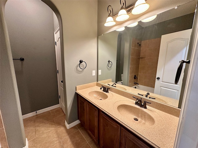 bathroom with tile patterned flooring, a sink, and toilet