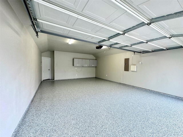 garage featuring electric panel and a garage door opener