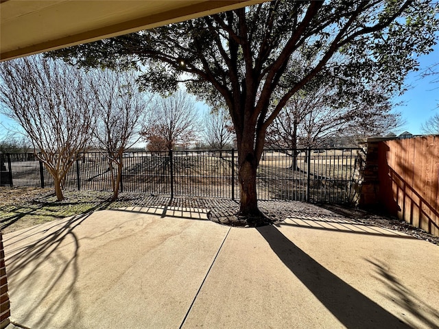 view of gate featuring a patio and fence