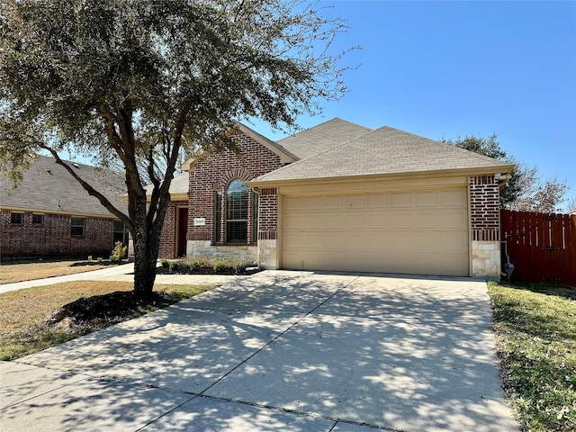 view of front of home with an attached garage, brick siding, fence, stone siding, and driveway