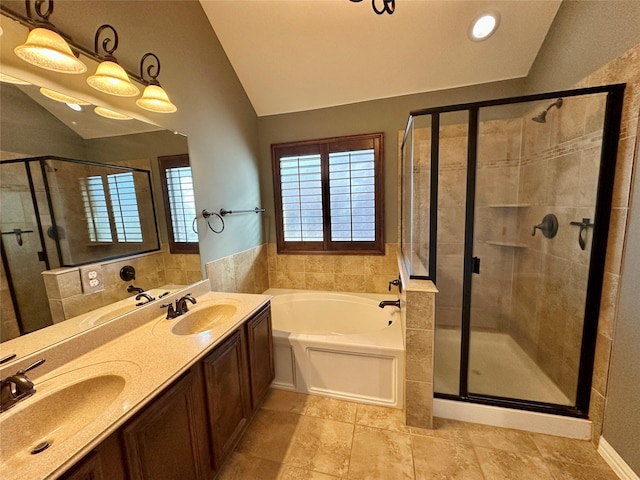 full bathroom with a stall shower, lofted ceiling, and a sink