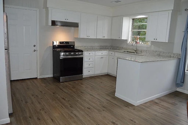 kitchen featuring stainless steel gas stove, under cabinet range hood, white cabinetry, and a sink