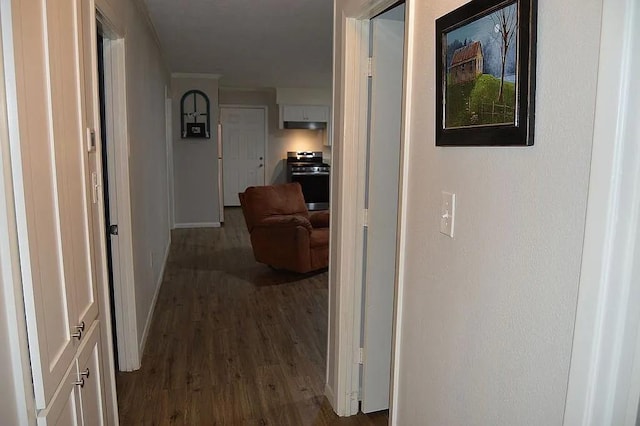 corridor with baseboards and dark wood finished floors