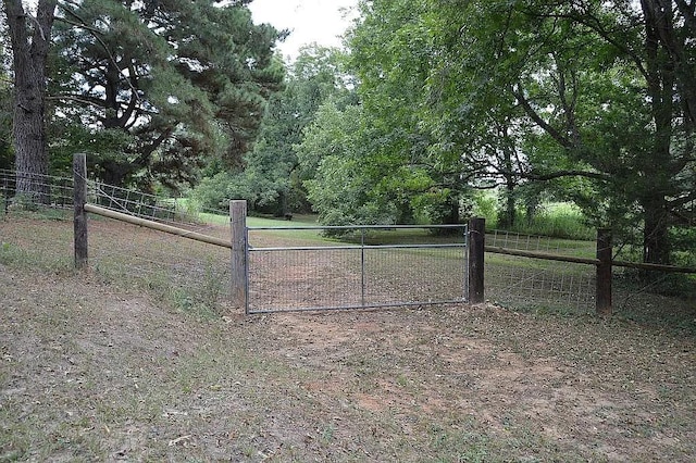 view of gate featuring fence