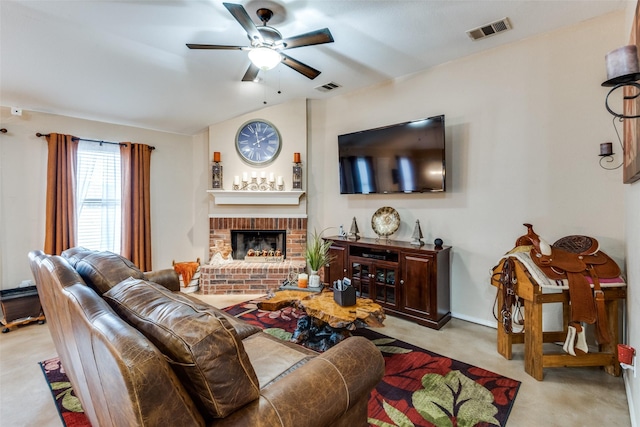 living area featuring a ceiling fan, visible vents, a fireplace, and carpet flooring