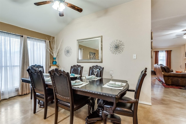 dining room featuring vaulted ceiling, a ceiling fan, and baseboards