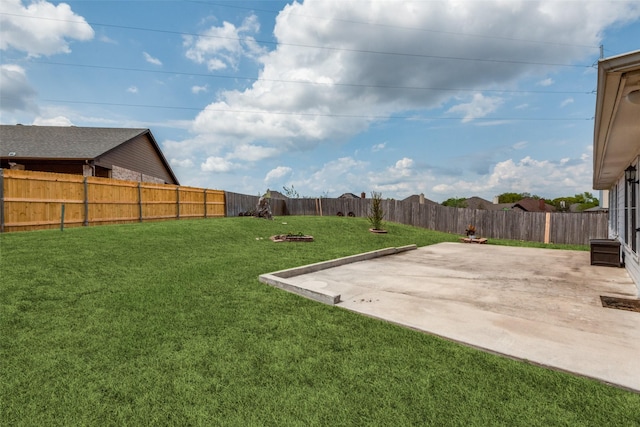 view of yard with a patio area and a fenced backyard