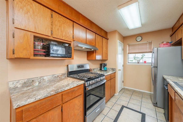 kitchen featuring a textured ceiling, light tile patterned flooring, under cabinet range hood, light countertops, and black appliances