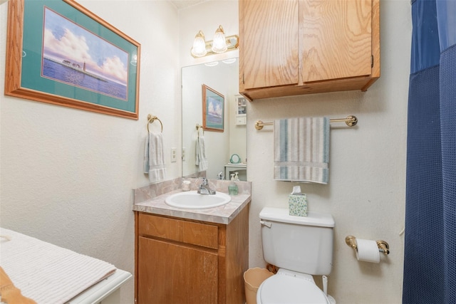 bathroom featuring toilet and vanity