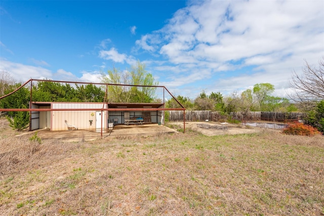 rear view of property featuring an outbuilding