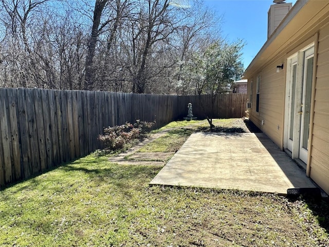 view of yard with a fenced backyard and a patio