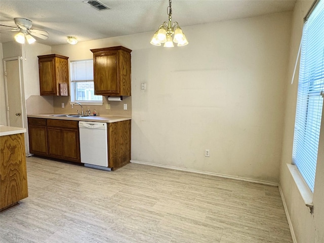 kitchen featuring visible vents, dishwasher, light countertops, light wood-type flooring, and a sink