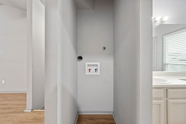 laundry room with laundry area, washer hookup, light wood-style floors, and hookup for an electric dryer