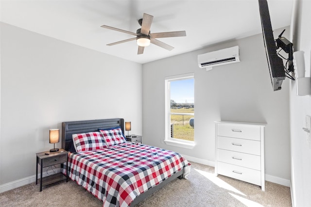 bedroom with a ceiling fan, a wall unit AC, light colored carpet, and baseboards