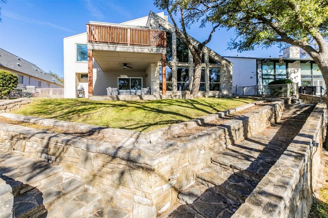 mid-century modern home with stone siding, driveway, a chimney, and an attached garage