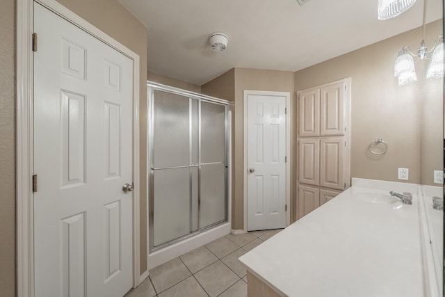 full bathroom featuring a stall shower, tile patterned flooring, and vanity