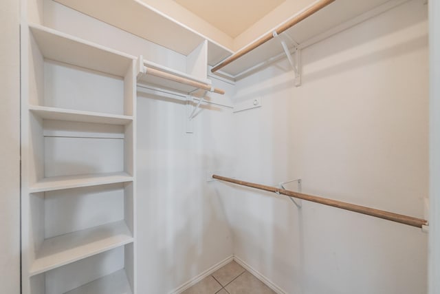 walk in closet featuring tile patterned flooring