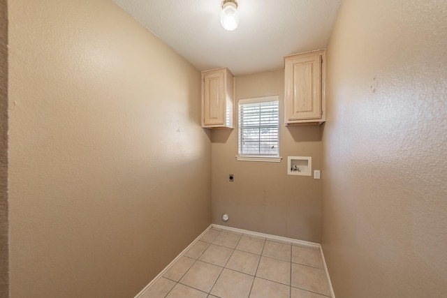 laundry room featuring light tile patterned floors, hookup for a washing machine, cabinet space, electric dryer hookup, and baseboards