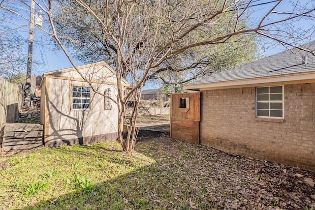 view of yard with an outdoor structure and fence