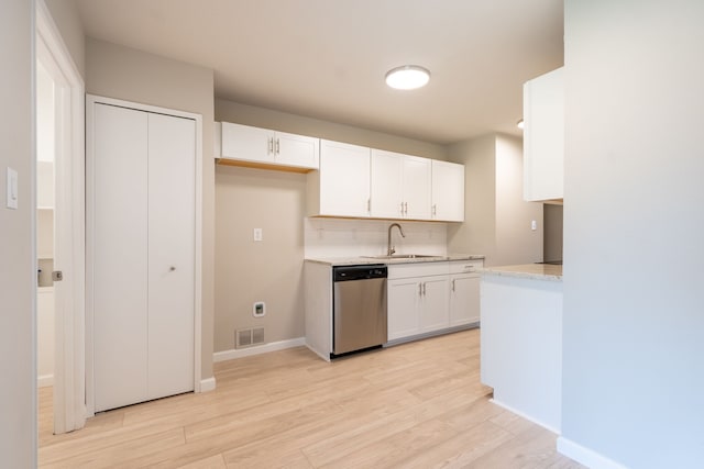 kitchen with light wood-type flooring, visible vents, a sink, and stainless steel dishwasher