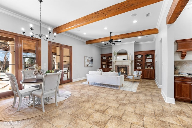 dining space with baseboards, visible vents, ornamental molding, beamed ceiling, and a fireplace