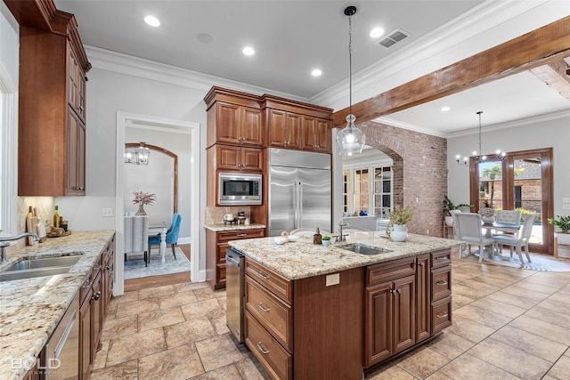 kitchen featuring arched walkways, visible vents, a sink, built in appliances, and a chandelier