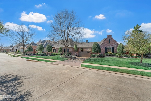 view of front facade with a residential view, a gate, brick siding, and a front lawn