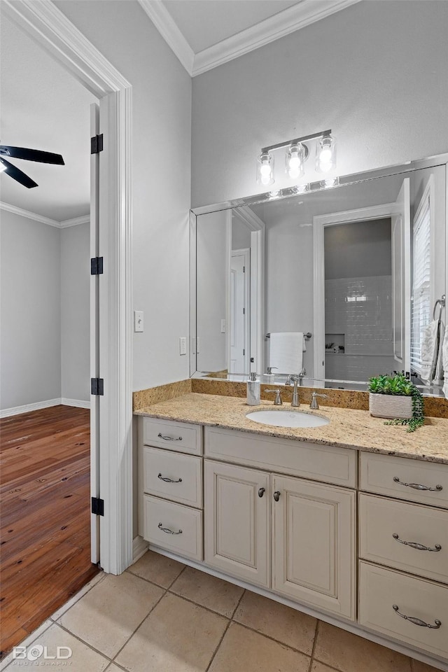 bathroom with tile patterned floors, crown molding, vanity, and ceiling fan