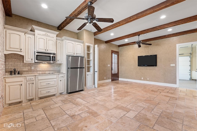 kitchen with ceiling fan, baseboards, stainless steel appliances, and open floor plan