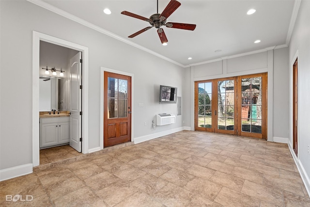 unfurnished living room with crown molding, a sink, and baseboards