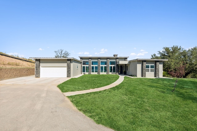 view of front facade with an attached garage, stone siding, concrete driveway, stucco siding, and a front yard