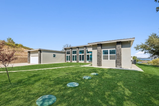 view of front of house with stone siding, a front yard, and stucco siding