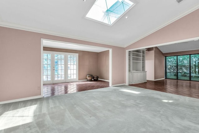 unfurnished living room featuring crown molding, lofted ceiling with skylight, carpet, and a healthy amount of sunlight