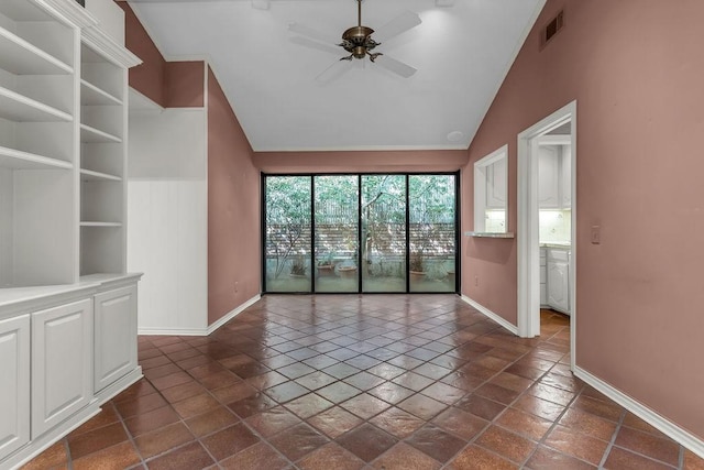 spare room with lofted ceiling, baseboards, visible vents, and a ceiling fan