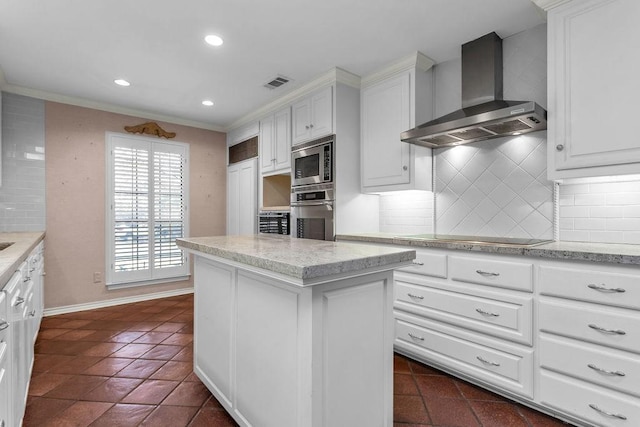 kitchen with visible vents, decorative backsplash, wall chimney exhaust hood, appliances with stainless steel finishes, and white cabinetry