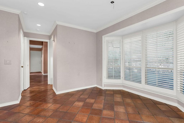 spare room featuring recessed lighting, crown molding, and baseboards