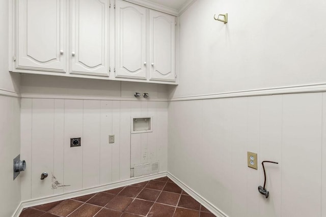 laundry room with hookup for a washing machine, cabinet space, hookup for an electric dryer, gas dryer hookup, and dark tile patterned floors