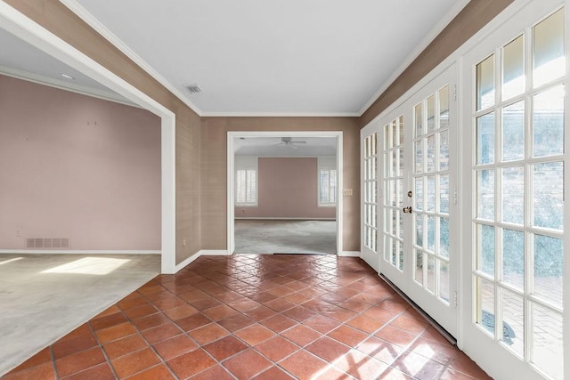 tiled spare room with carpet floors, baseboards, visible vents, and ornamental molding