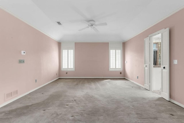 spare room with a wealth of natural light, ornamental molding, and visible vents